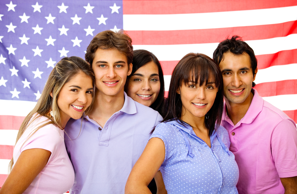 Group of students learning English as a foreign language with the American flag on the background